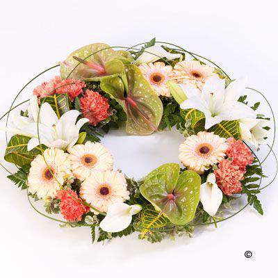<h2>Large Tropical Exotic Wreath | Funeral Flowers</h2>
<ul>
<li>Approximate Size W 44cm H 44cm (large)</li>
<li>Hand created exotic wreath in fresh flowers</li>
<li>To give you the best we may occasionally need to make substitutes</li>
<li>Funeral Flowers will be delivered at least 2 hours before the funeral</li>
<li>For delivery area coverage see below</li>
</ul>
<br>
<h2>Liverpool Flower Delivery</h2>
<p>We have a wide selection of Funeral Wreaths offered for Liverpool Flower Delivery. Funeral Wreaths can be provided for you in Liverpool, Merseyside and we can organize Funeral flower deliveries for you nationwide. Funeral Flowers can be delivered to the Funeral directors or a house address. They can not be delivered to the crematorium or the church.</p>
<br>
<h2>Flower Delivery Coverage</h2>
<p>Our shop delivers funeral flowers to the following Liverpool postcodes L1 L2 L3 L4 L5 L6 L7 L8 L11 L12 L13 L14 L15 L16 L17 L18 L19 L24 L25 L26 L27 L36 L70 If your order is for an area outside of these we can organise delivery for you through our network of florists. We will ask them to make as close as possible to the image but because of the difference in stock and sundry items it may not be exact.</p>
<br>
<h2>Liverpool Funeral Flowers | Wreaths</h2>
<p>This large elegant wreath-shaped design has been loving handcrafted by our florists. It features an exotic mix of anthuriums, calla lilies, gerbera, lilies, carnations in green, orange and white together with tropical foliage gives it a contemporary feel.</p>
<br>
<p>A funeral wreath is flowers arranged in a circular shape with a hole in the centre. This circular shape symbolises the circle of life or eternal life. They are suitable for sending directly to a funeral whether you are family or a friend.</p>
<br>
<p>Contents of 14 inch oasis ring: 5 green and pink anthuriums, 8 peach gerberas, 5 white calla lilies, 3 white lily, 10 orange carnations with mixed tropical foliages and looped steel grass.</p>
<br>
<h2>Best Florist in Liverpool</h2>
<p>Trust Award-winning Liverpool Florist, Booker Flowers and Gifts, to deliver funeral flowers fitting for the occasion delivered in Liverpool, Merseyside and beyond. Our funeral flowers are handcrafted by our team of professional fully qualified who not only lovingly hand make our designs but hand-deliver them, ensuring all our customers are delighted with their flowers. Booker Flowers and Gifts your local Liverpool Flower shop.</p>
<br>
<p><em>Jane Catherine and Family - Review by Post - Funeral Florist Liverpool</em></p>
<br>
<p><em>Thank you so much for the amazing flowers you arranged for our mum she would have loved them. Love Jane, Catherine and family</em></p>
<br>